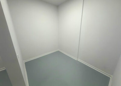 Acabados de grado alimenticio con molduras sanitarias blancas en habitación de envasado hermética